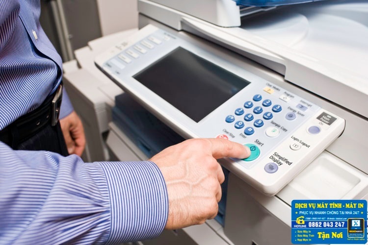 Kỹ thuật viên đang khởi động thử máy photocopy